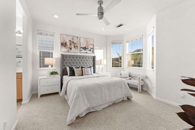a bedroom with bed and a chandelier
