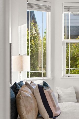 a bed sitting in a bedroom next to a window