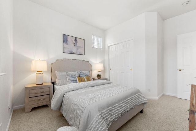 a bedroom with a bed and a lamp