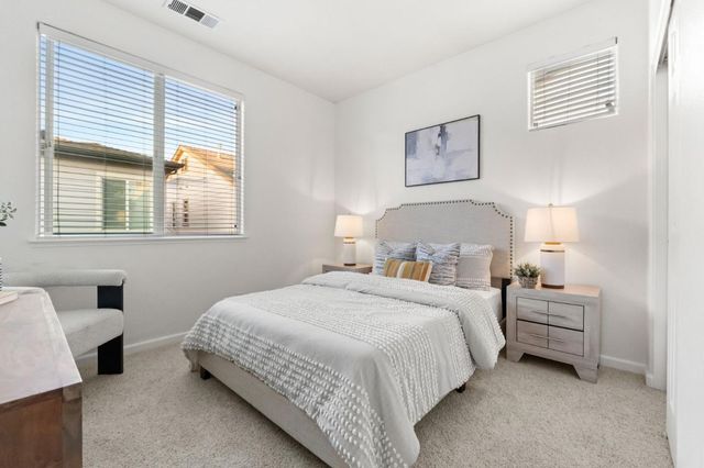 a bedroom with bed and a window