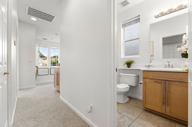 a bathroom with a sink a toilet and a mirror