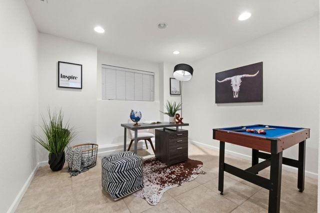 a work room with furniture and a potted plant
