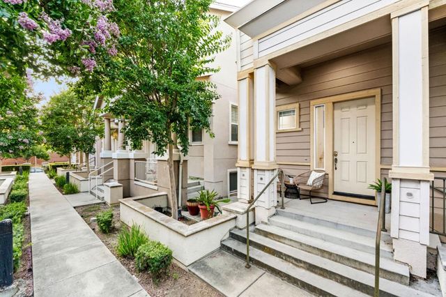 a view of house with patio outdoor seating and city view