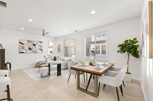 a living room with furniture potted plant and a window