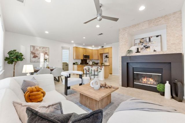 a living room with furniture a fireplace and window