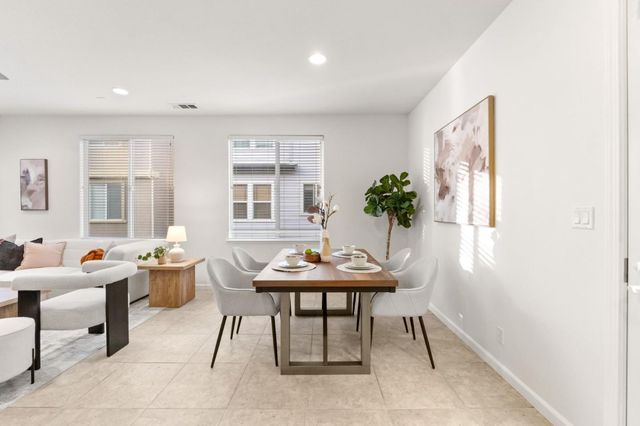 a view of a dining room with furniture and window
