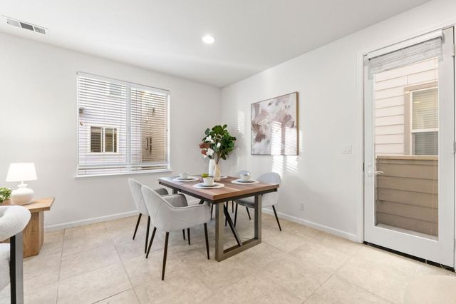 a view of a dining room with furniture and window