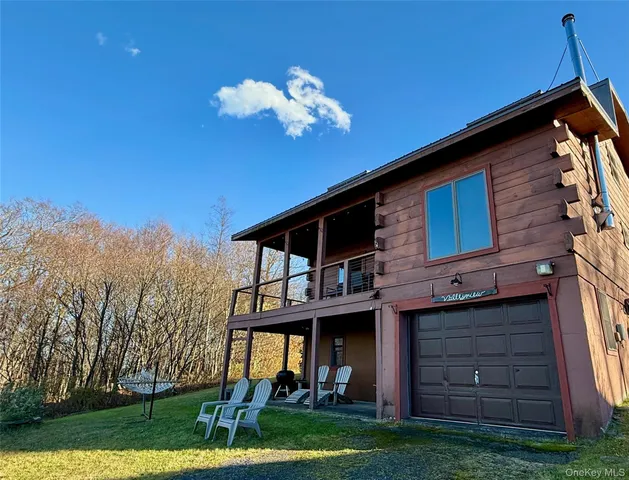 a view of a house with a backyard space