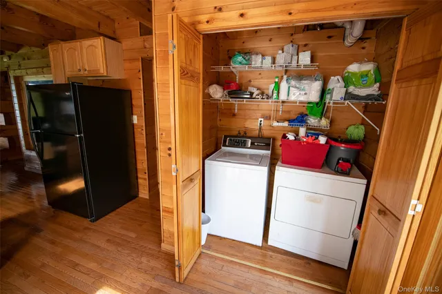 a bedroom with a bed and a wooden floor