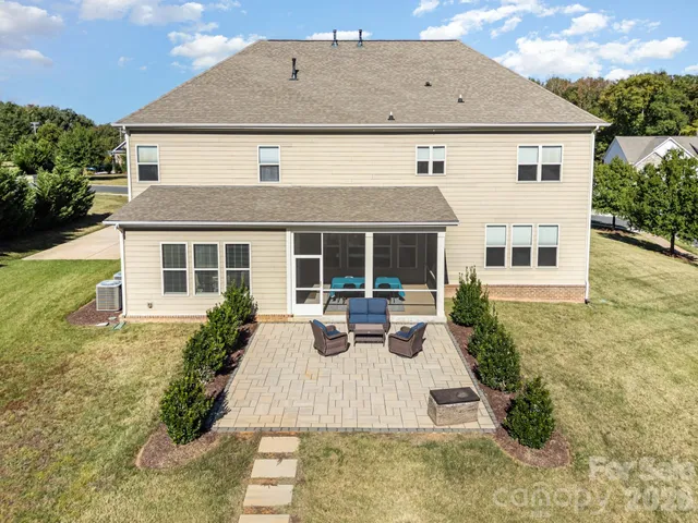 an aerial view of a house with a swimming pool