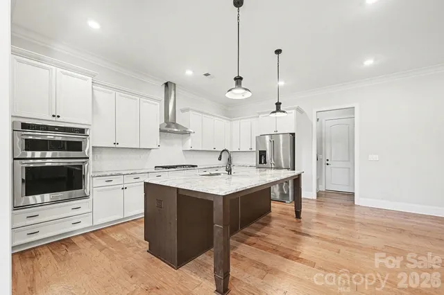 a kitchen with a stove a sink and a refrigerator