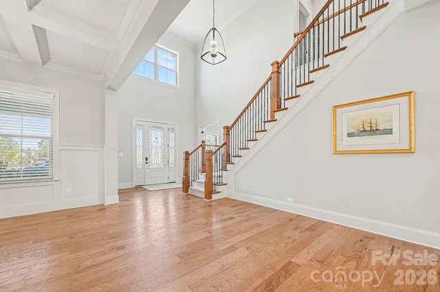 a large kitchen with stainless steel appliances kitchen island a large counter top and a wooden floors