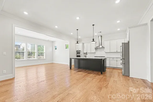 a kitchen with kitchen island a sink stainless steel appliances and cabinets