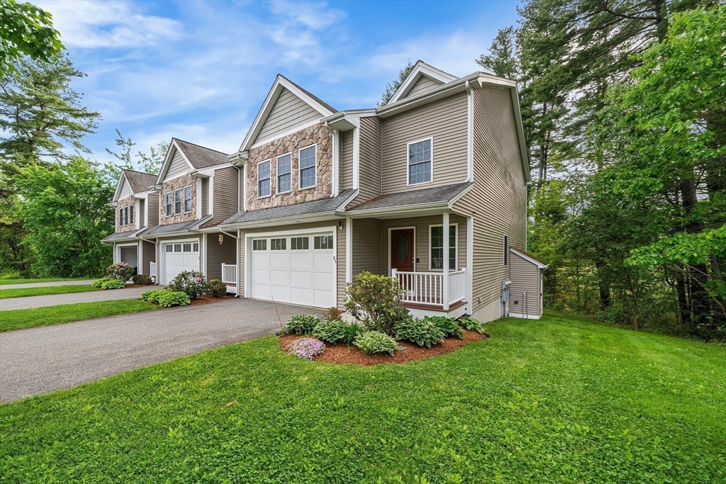 215 Rangeway Road, Unit 31 Billerica, MA 01862 - Photo 3 of 40 a front view of a house with a yard and porch