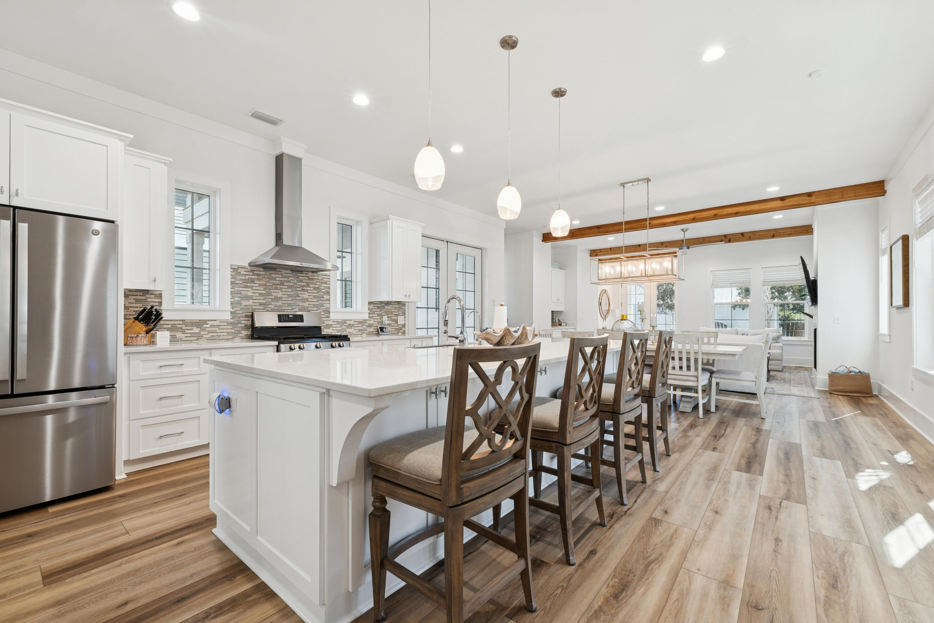 342 Beach Bike Way Inlet Beach Inlet Beach, FL 32461 - Photo 20 of 77 a kitchen with white cabinets stainless steel appliances and dining table