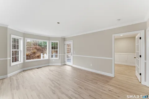 a kitchen with stainless steel appliances granite countertop a stove and a wooden floors