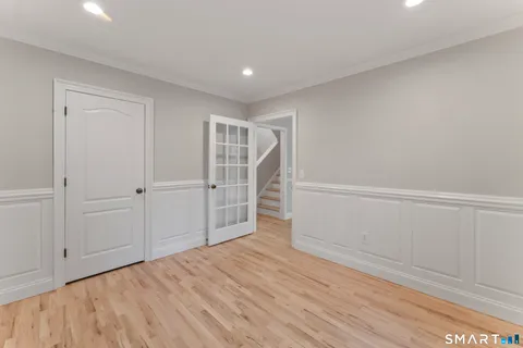 a view of empty room with wooden floor