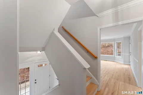 a view of an empty room and wooden floor