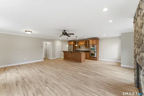 a kitchen with stainless steel appliances granite countertop a sink a center island and cabinets