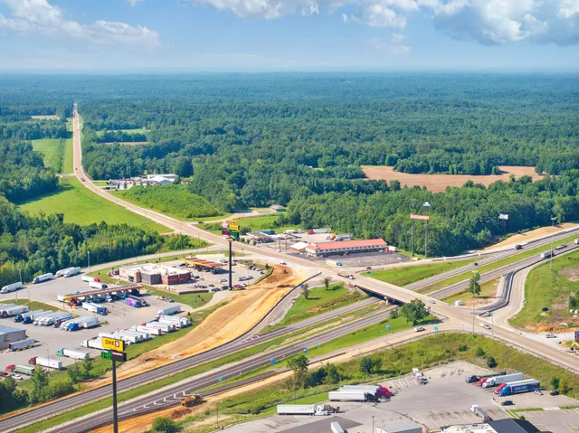 a view of a yard with potted plants