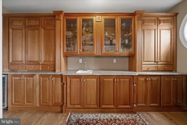 a view of a room with wooden floor and a table