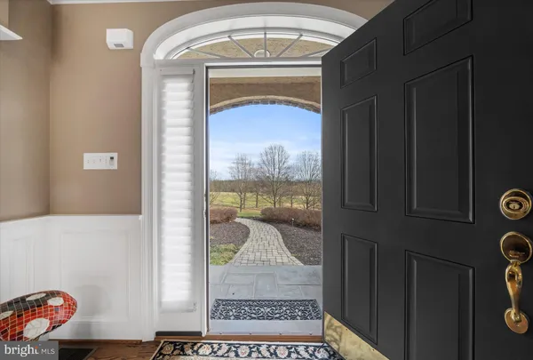 a bedroom with furniture and a large window