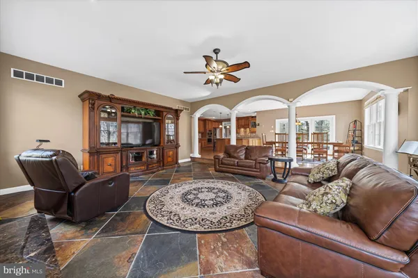 a living room with furniture a wooden floor and a window