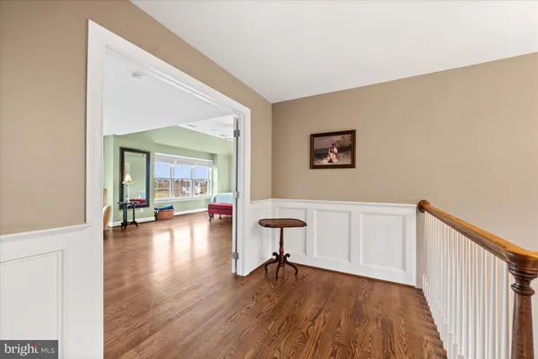 a view of a room with furniture and wooden floor