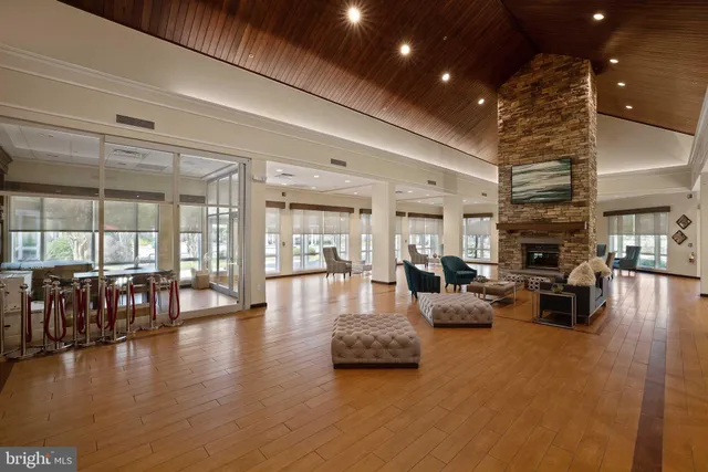 a living room with fireplace furniture and a table