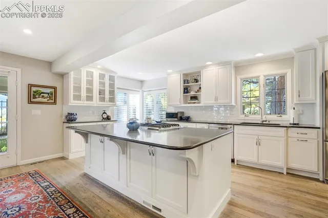 a kitchen with sink stove and cabinets