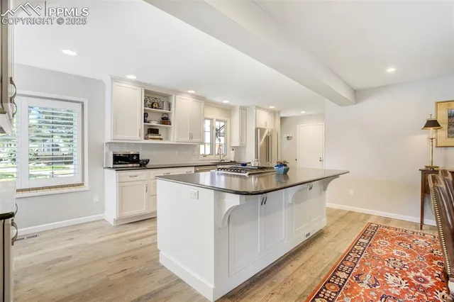 a kitchen with stainless steel appliances a sink and wooden cabinets
