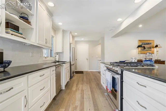 a kitchen with stainless steel appliances granite countertop a stove and a sink