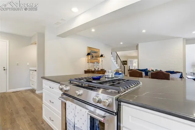 a kitchen with stainless steel appliances granite countertop a stove and a cabinets