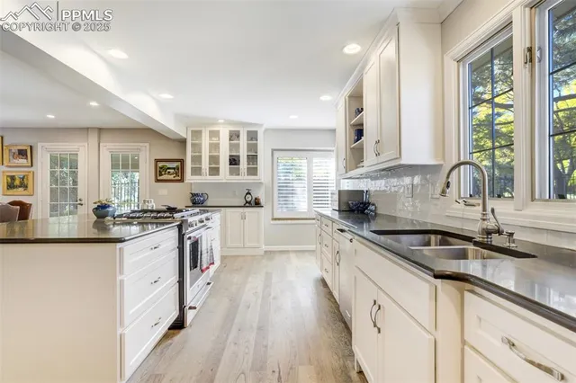 a kitchen with granite countertop a sink and cabinets
