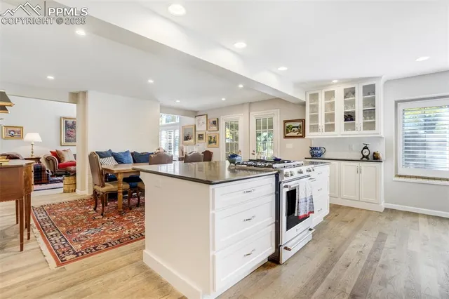 a kitchen with counter top space and wooden floor