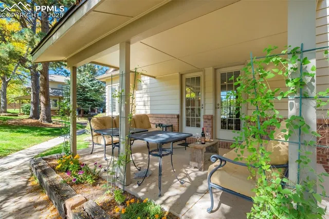 a building outdoor space with patio furniture and potted plants