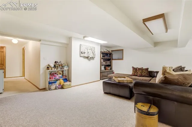 a living room with lots of furniture and a lamp