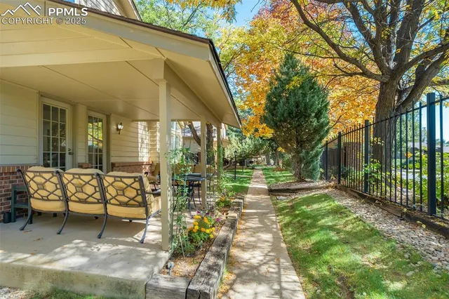 a view of a house with backyard and sitting area