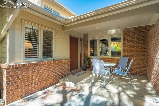 a view of a two chairs in the patio