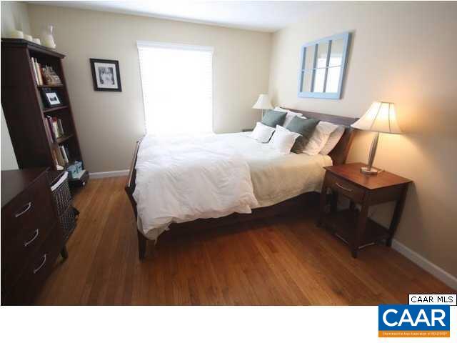 2422 Barracks Place, Unit 3 Charlottesville, VA 22901 - Photo 3 of 6 a bedroom with a bed a mirror and lamp