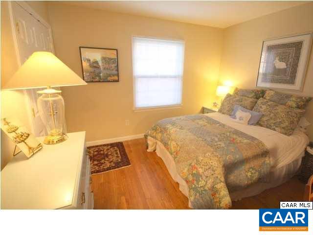 2422 Barracks Place, Unit 3 Charlottesville, VA 22901 - Photo 4 of 6 a bedroom with a bed and wooden floor