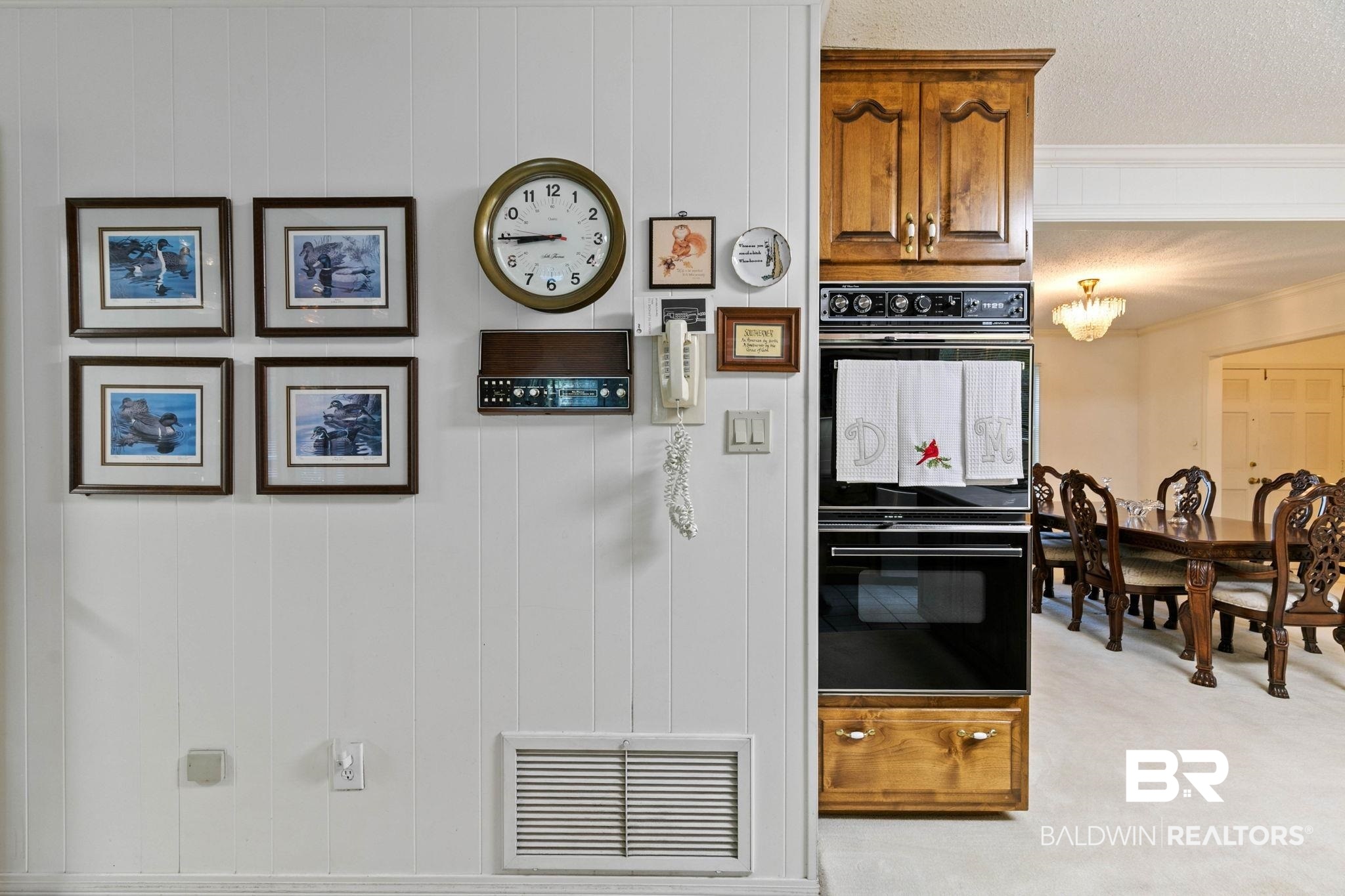 752 Evergreen Street Fairhope, AL 36532 - Photo 15 of 100 Kitchen with light carpet, crown molding, and brown cabinets