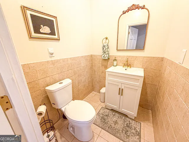 a aerial view of house with yard and trees in the background