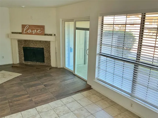 a view of a livingroom with an empty space and a fireplace