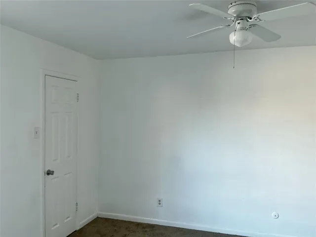 a view of a room with window and ceiling fan