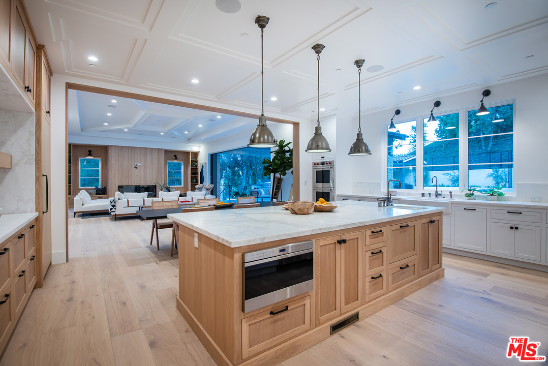 5716 Jed Smith Road Hidden Hills, CA 91302 - Photo 12 of 53 a kitchen with stainless steel appliances granite countertop a stove and a wooden floors