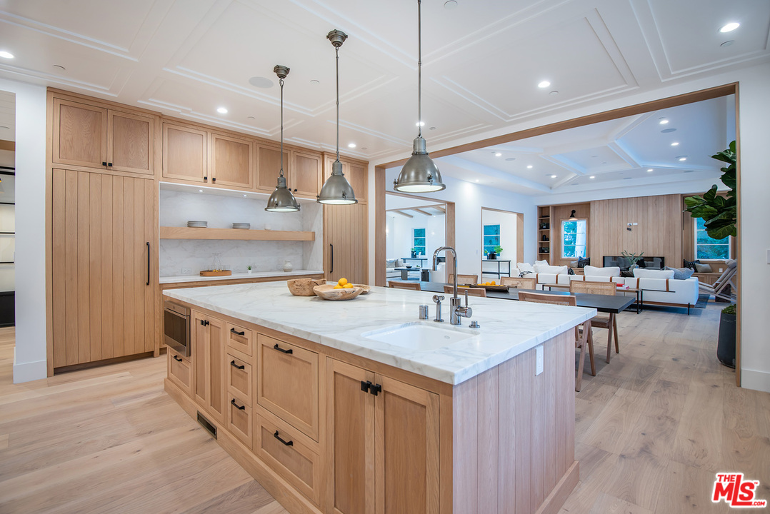 5716 Jed Smith Road Hidden Hills, CA 91302 - Photo 13 of 53 a open kitchen with stainless steel appliances granite countertop a sink a counter space and wooden floors