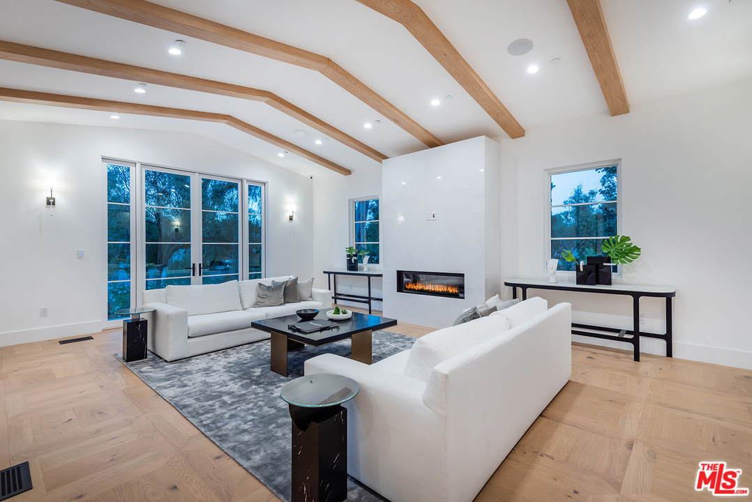 5716 Jed Smith Road Hidden Hills, CA 91302 - Photo 15 of 53 a living room with furniture and a large window