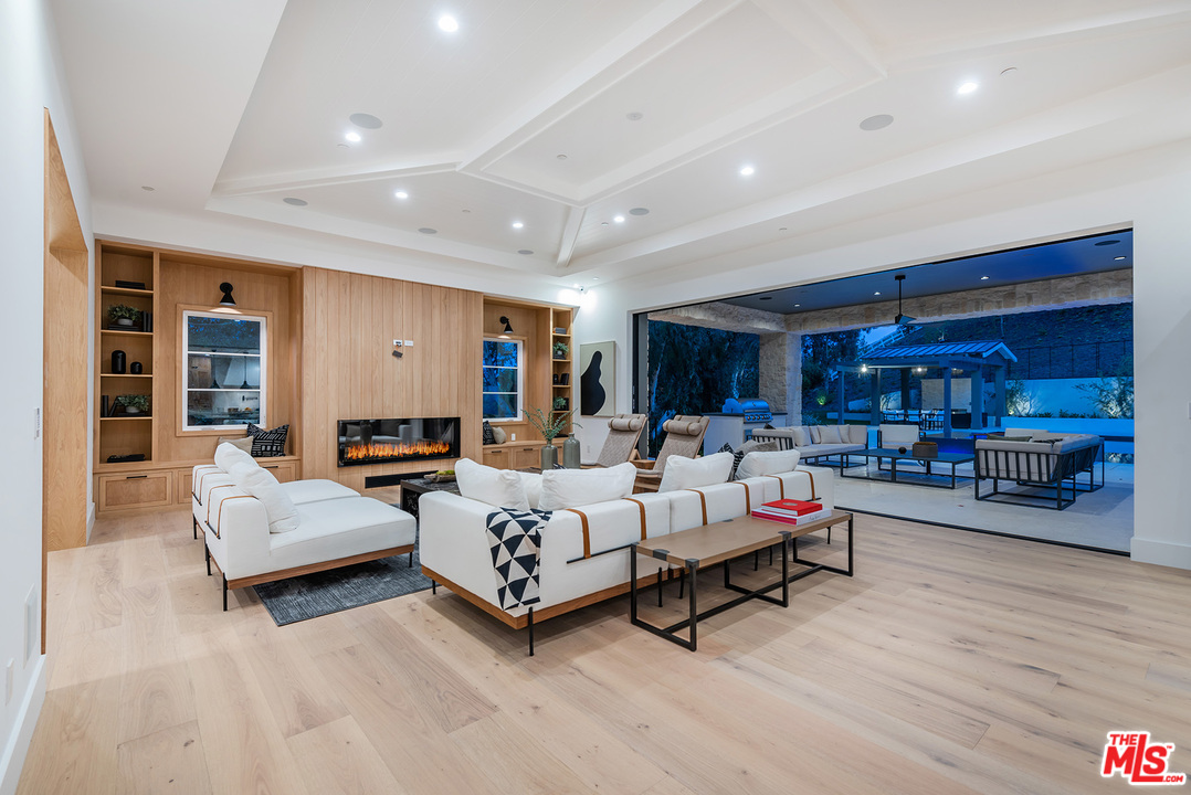 5716 Jed Smith Road Hidden Hills, CA 91302 - Photo 21 of 53 a living room with furniture and a large window