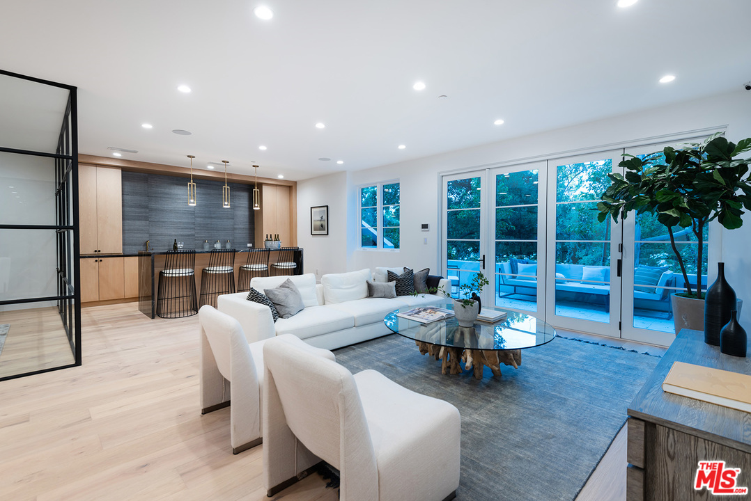 5716 Jed Smith Road Hidden Hills, CA 91302 - Photo 29 of 53 a living room with fireplace furniture and a potted plant